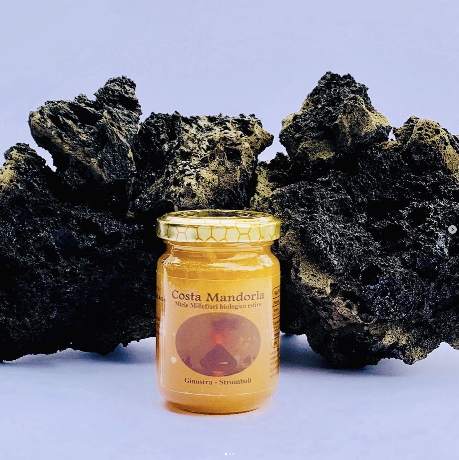 A jar of Costa Mandorla honey on Stromboli lava rock
